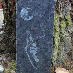 etched granite garden art of moon and wolf